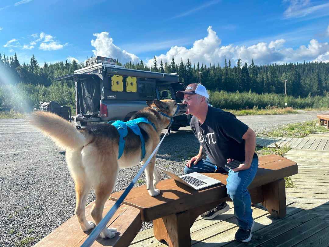 Jim checking orders with Alaska Highway RV internet access at Tetlin Junction in the Yukon.