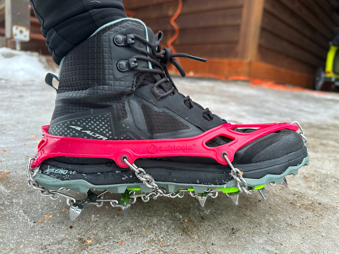 Wilderness woman wear microspikes over Altra running shoes