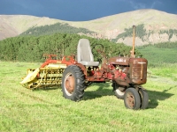 Antique Farmall Tractor with Rake in Vickers Ranch Hayfield