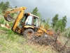 Hauling felled tree with 4WD Case 580K backhoe