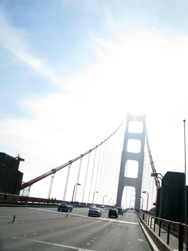 Sun shines through Golden Gate Bridge