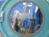 Laundryman Jim framed by Cissel commercial dryer door