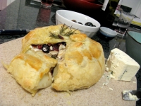 Homemade baked brie in pastry puff with almonds, cranberries and honey by Sonja