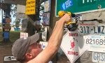 Hanging our sign at Signpost Forest in Watson Lake, BC