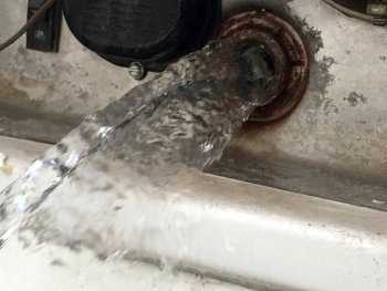 Drain RV water heater to replace check valve.