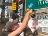 Hanging our sign at Signpost Forest in Watson Lake, BC