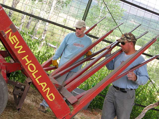 Jim and Paul ponder broken stacker at Vickers Ranch Hay Barn