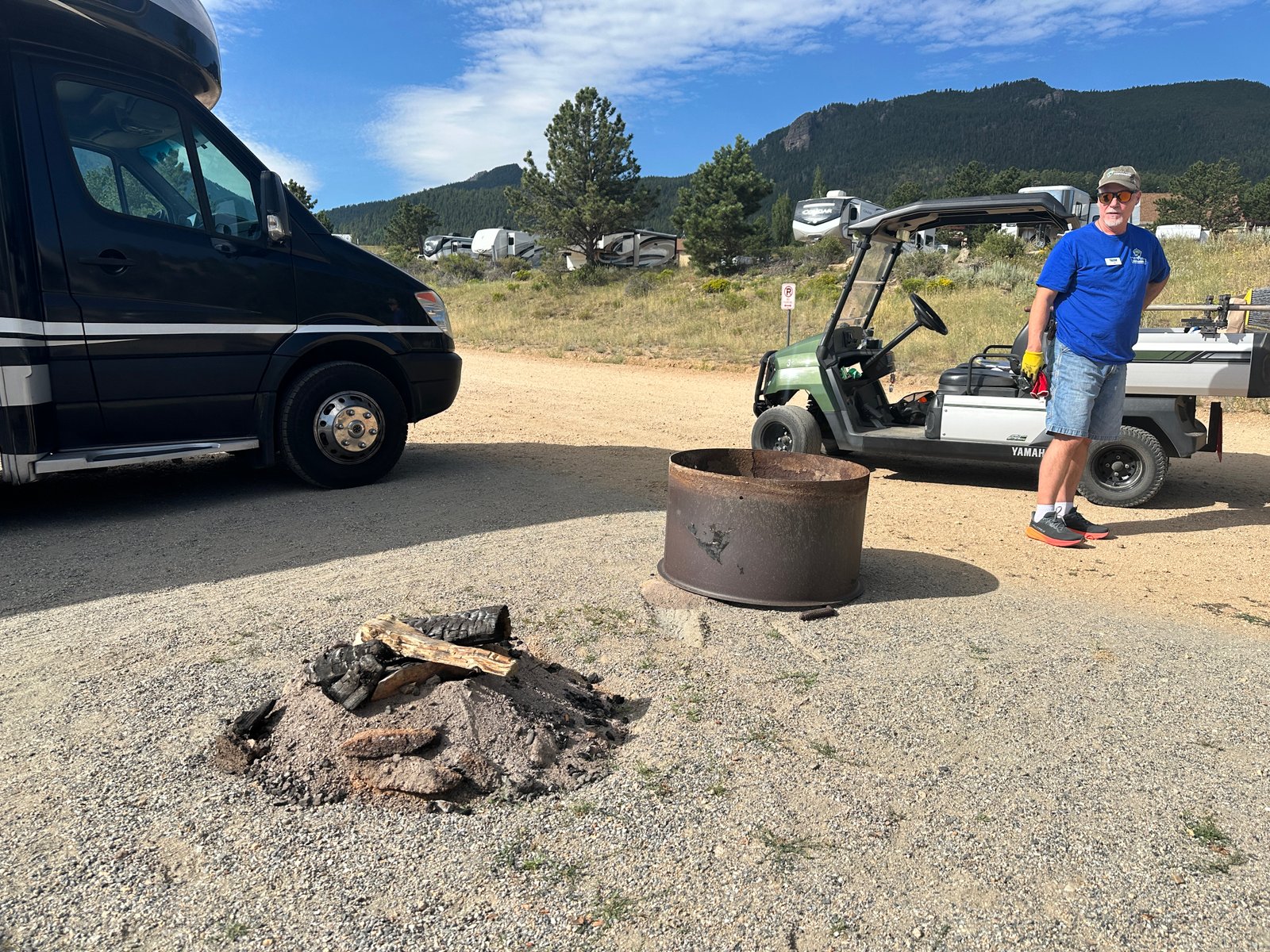 A campground host pet peeve as Jim moves the camp fire ring back to where it goes.