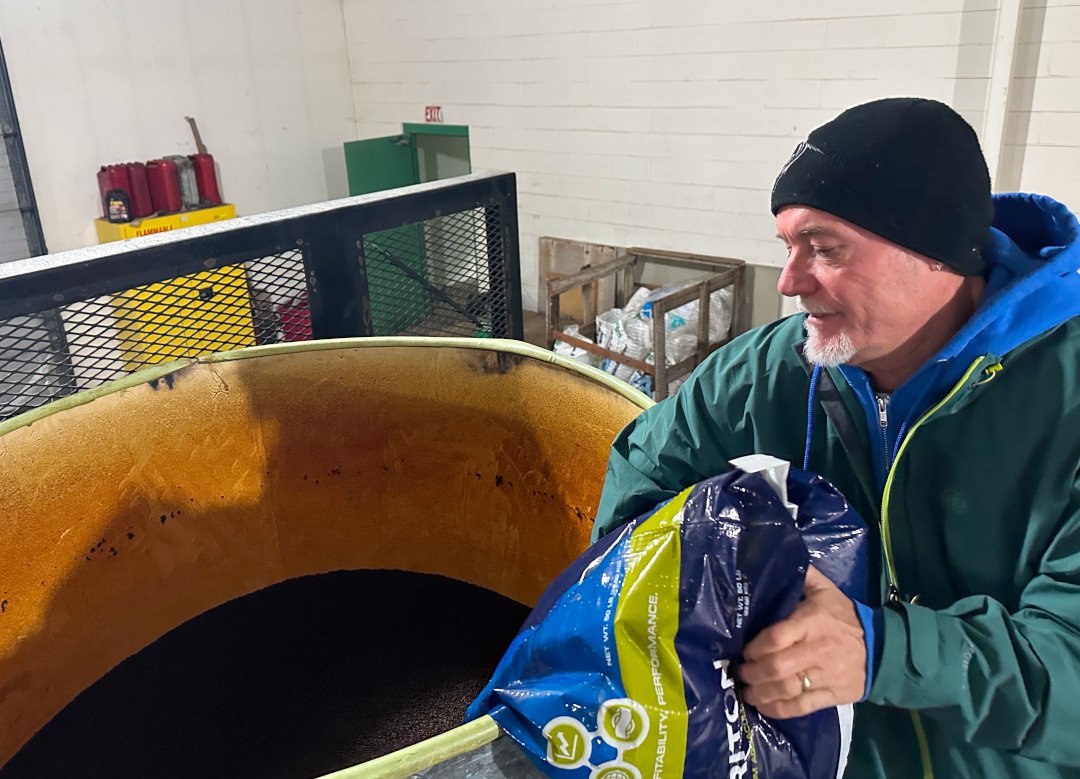 Jim loading up the fish food hopper.