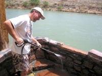 Jim power-washes hot mineral bath tubs at Riverbend Hot Springs