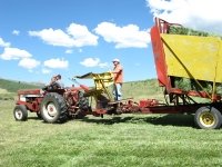 Jim rides the stacker back to the hay barn with a full load