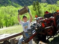 Rene splitting logs workamping at Vickers Guest Ranch
