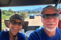 Rene and Jim escort camper to tent site