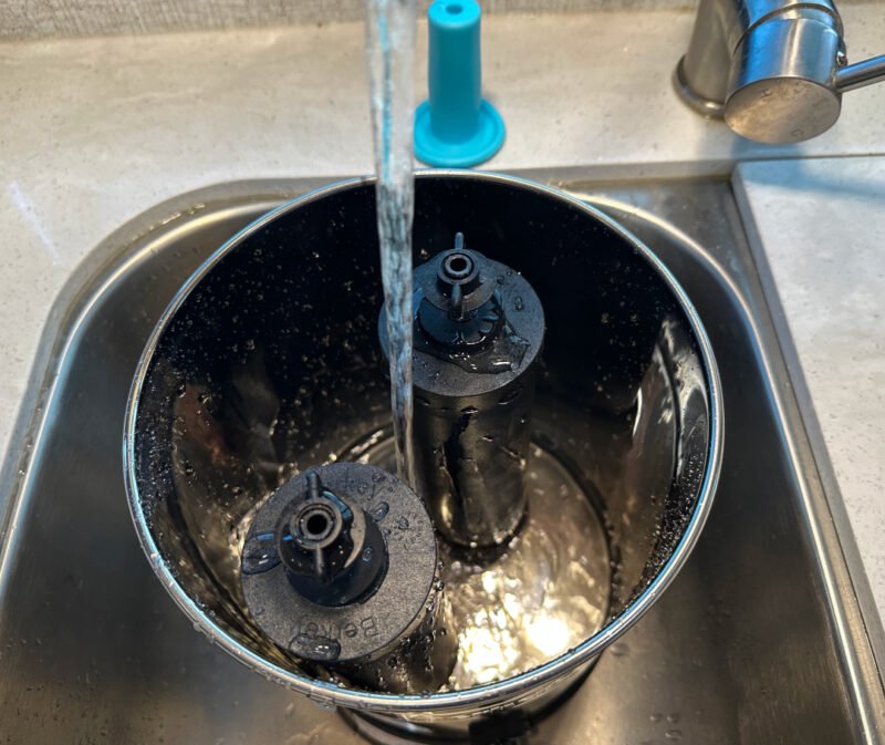 Filling Berkey Travel Water Filter chamber to prime water filters before use